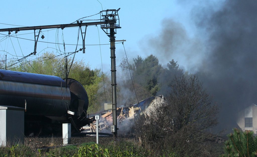 epa03686977 Part of a freight train is seen after an explosion on railway tracks near Schellebelle, northern Belgium early 4 May 2013  when a chemical freight train exploded. The train contained chemical products and emergency services evacuated 250 residents near the place of the crash.  EPA/OLIVIER HOSLET