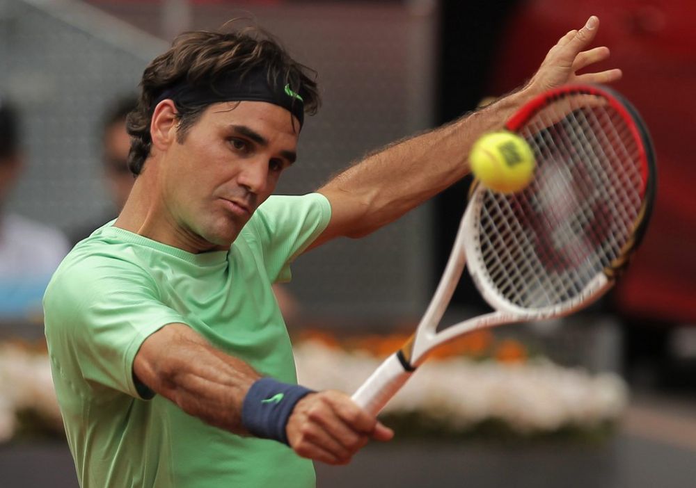 Roger Federer from Switzerland returns the ball during the match against Radek Stepanek from Czech Republic at the Madrid Open tennis tournament, in Madrid, Tuesday, May 7, 2013. (AP Photo/Andres Kudacki)