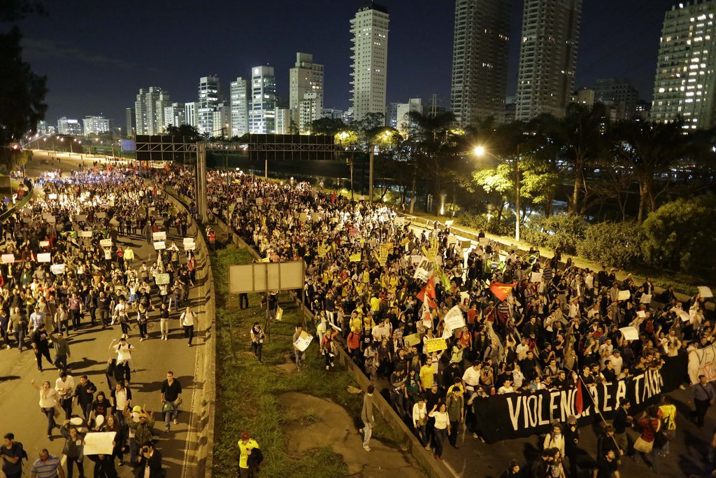 Protestors march in Sao Paulo, Brazil, Monday, June 17, 2013. Protesters massed in at least seven Brazilian cities Monday for another round of demonstrations voicing disgruntlement about life in the country, raising questions about security during big events like the current Confederations Cup and a papal visit next month. (AP Photo/Nelson Antoine)