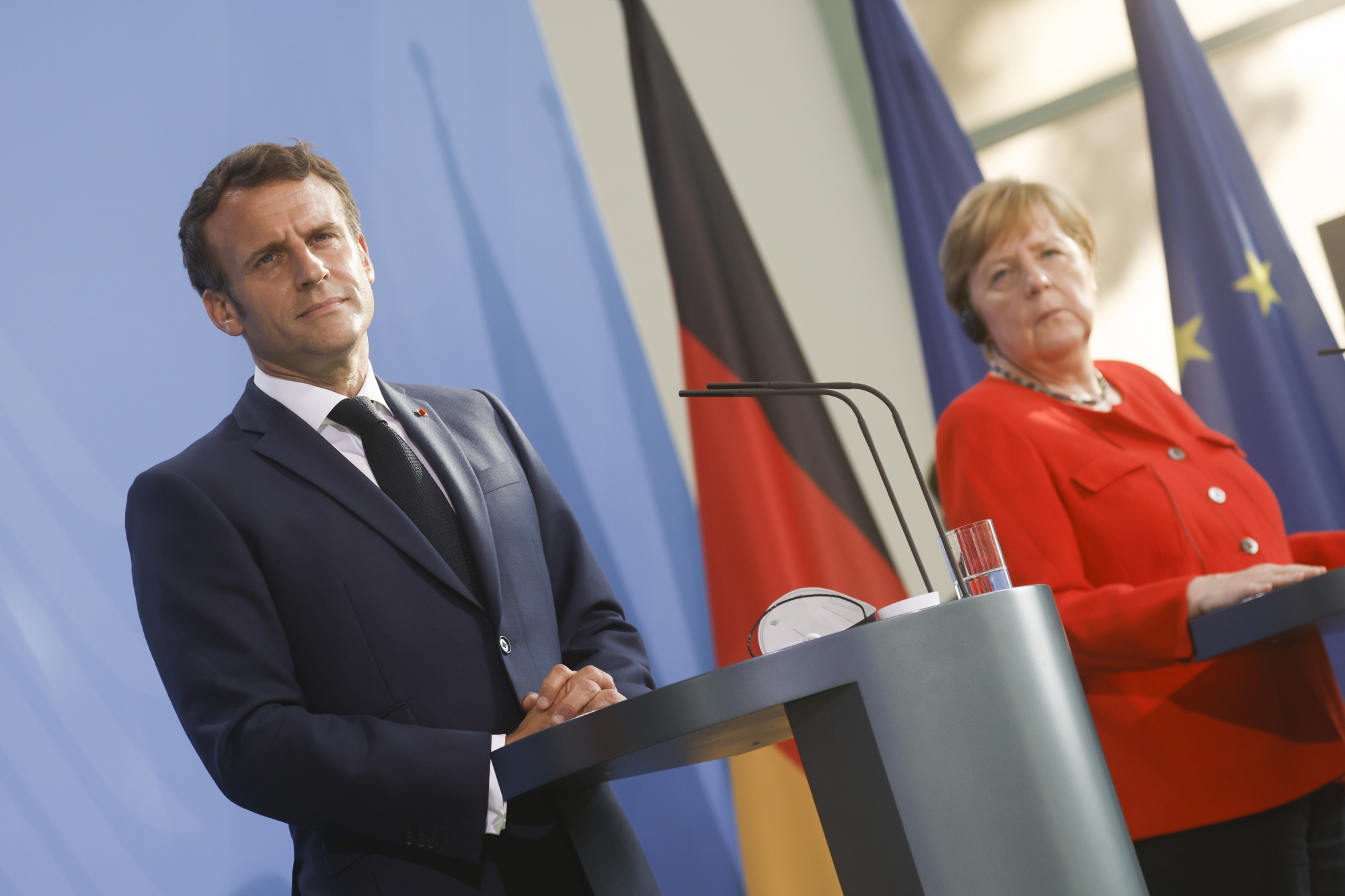 epa09283559 French President Emmanuel Macron (L) and German Chancellor Angela Merkel (R) give a news statement in Berlin, Germany, 18 June 2021. President Macron and Chancellor Merkel met for bilateral talks. EPA/AXEL SCHMIDT / POOL