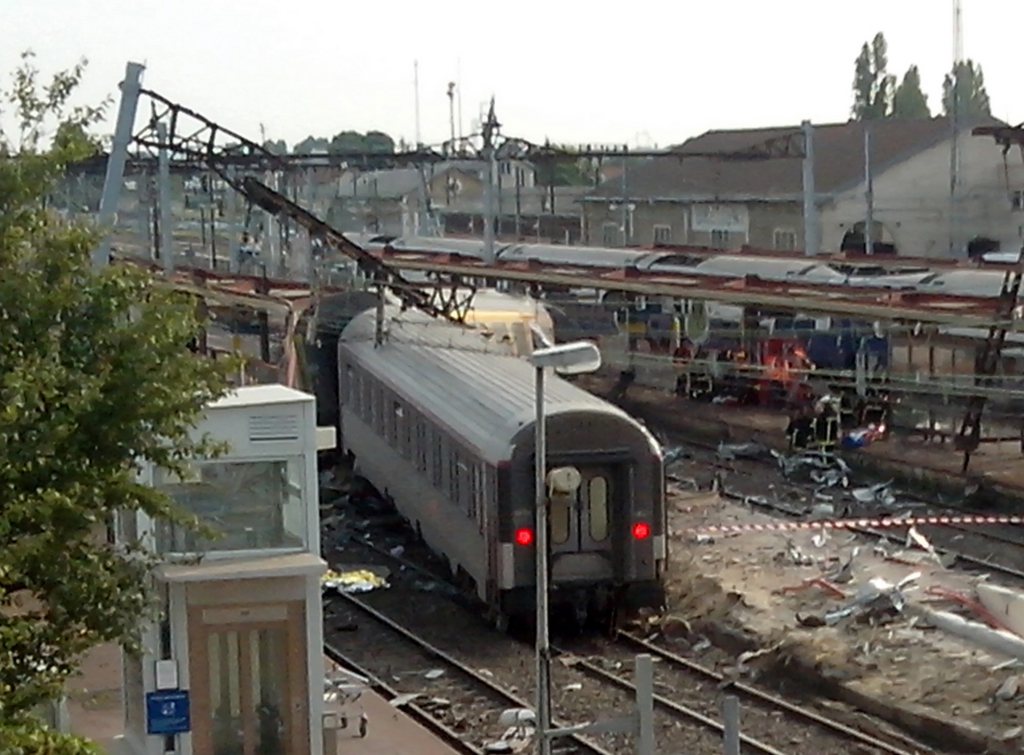A view of the Bretigny sur Orge train station, south of Paris, after a train derailed Friday July, 12, 2013. A packed passenger train skidded off its rails after leaving Paris on Friday, leaving seven people believed dead and dozens injured as train cars slammed into each other and overturned, authorities said. (AP Photo)