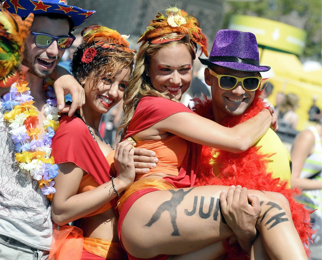 Participants in fancy dresses of the annual Street Parade celebrate and dance in the city center of Zurich, Switzerland, Saturday, August 10,  2013. Hundreds of thousands of ravers participate in the event. (KEYSTONE/Walter Bieri)
