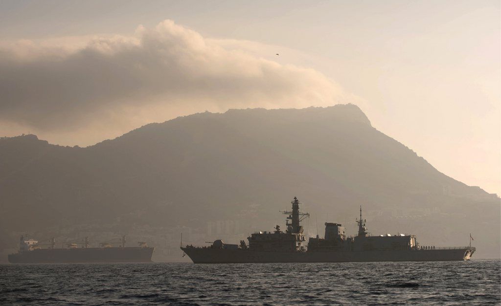 With the rock of Gibraltar in the background, Britain's Royal Navy ship HMS Westminster sails along the Gibraltar stretch near to La Linea de la Concepcion, Spain, Monday, Aug. 19, 2013. The British government said it is considering taking Spain to court if it does not ease border checks on traffic entering the disputed enclave of Gibraltar. Spain has long laid claim to Gibraltar, and the tiny territory on the southern tip of the Iberian peninsula is the source of occasional diplomatic friction between Madrid and London. The latest spat involved an artificial reef being built in Gibraltar that Spain said is hurting its fishermen. It has floated the idea of charging border fees as compensation. U.K. officials.  (AP Photo/Laura Leon)