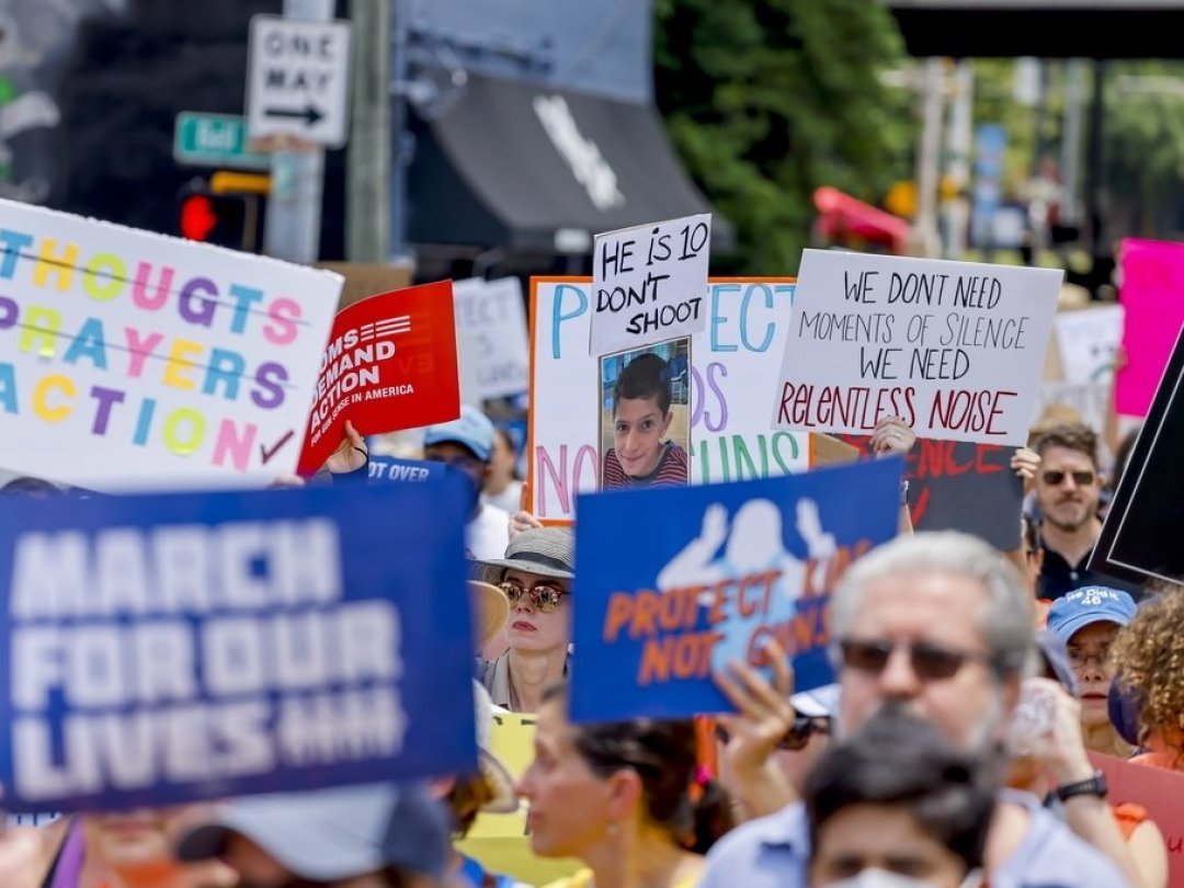 Des personnes tiennent des pancartes tout en participant à la manifestation "March For Our Lives" contre la violence armée à Atlanta, en Géorgie, aux États-Unis, le 11 juin 2022.