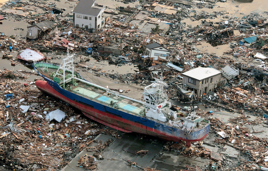 A vessel sits after it was washed away by tsunami into urban area in Kesennuma, Miyagi, northern Japan Saturday, March 12, 2011 after Japan's biggest recorded earthquake slammed into its eastern coast Friday. (AP Photo/Kyodo News)  MANDATORY CREDIT, NO LICENSING ALLOWED IN CHINA, HONG  KONG, JAPAN, SOUTH KOREA AND FRANCE
