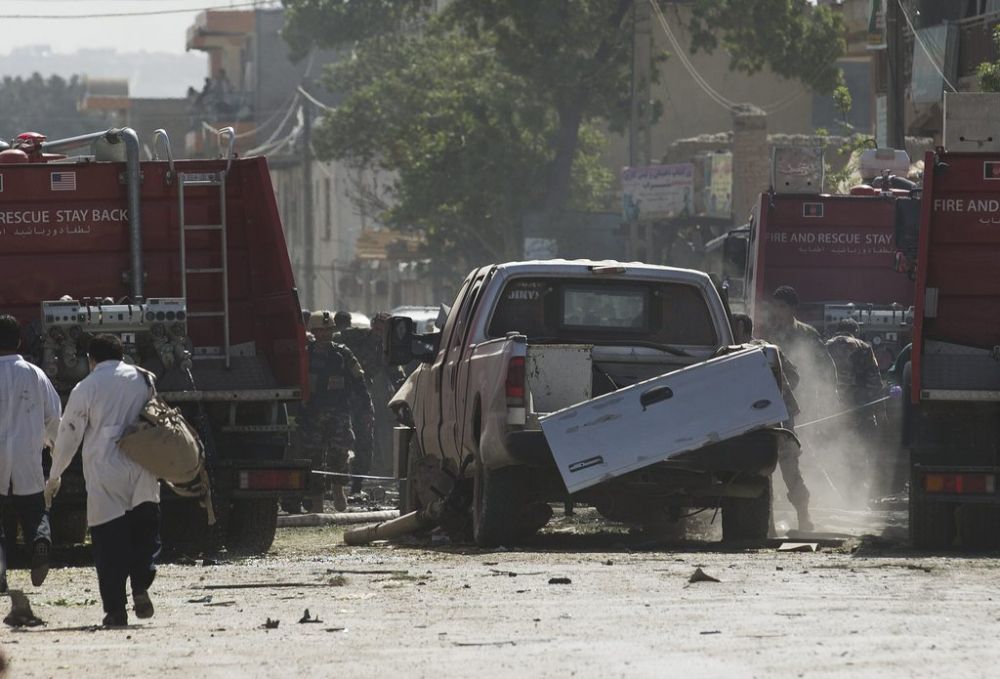Afghan and U.S. soldiers arrive to the scene where a suicide car bomber attacked a NATO convoy in Kabul, Afghanistan, Thursday, May 16, 2013. A Muslim militant group, Hizb-e-Islami, claimed responsibility for the early morning attack, killing at least six people in the explosion and wounding more than 30, police and hospital officials said. The powerful explosion rattled buildings on the other side of Kabul and sent a pillar of white smoke into the sky in the city's east. (AP Photo/Anja Niedringhaus)