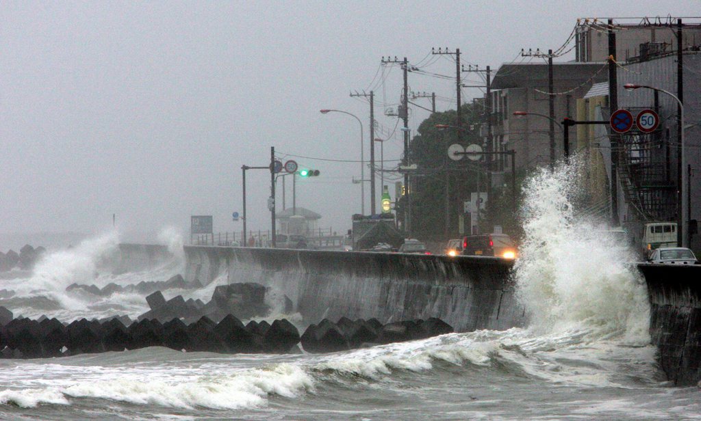 epa01111063 High waves hit a breakwater in Kamakura, southwest of Tokyo, Japan, 06 September 2007. Air and land transport are disrupted as Typhoon Fitow approaches Japan's main island of Honshu, heading to make landfall in Tokyo area early Friday.  EPA/FRANCK ROBICHON