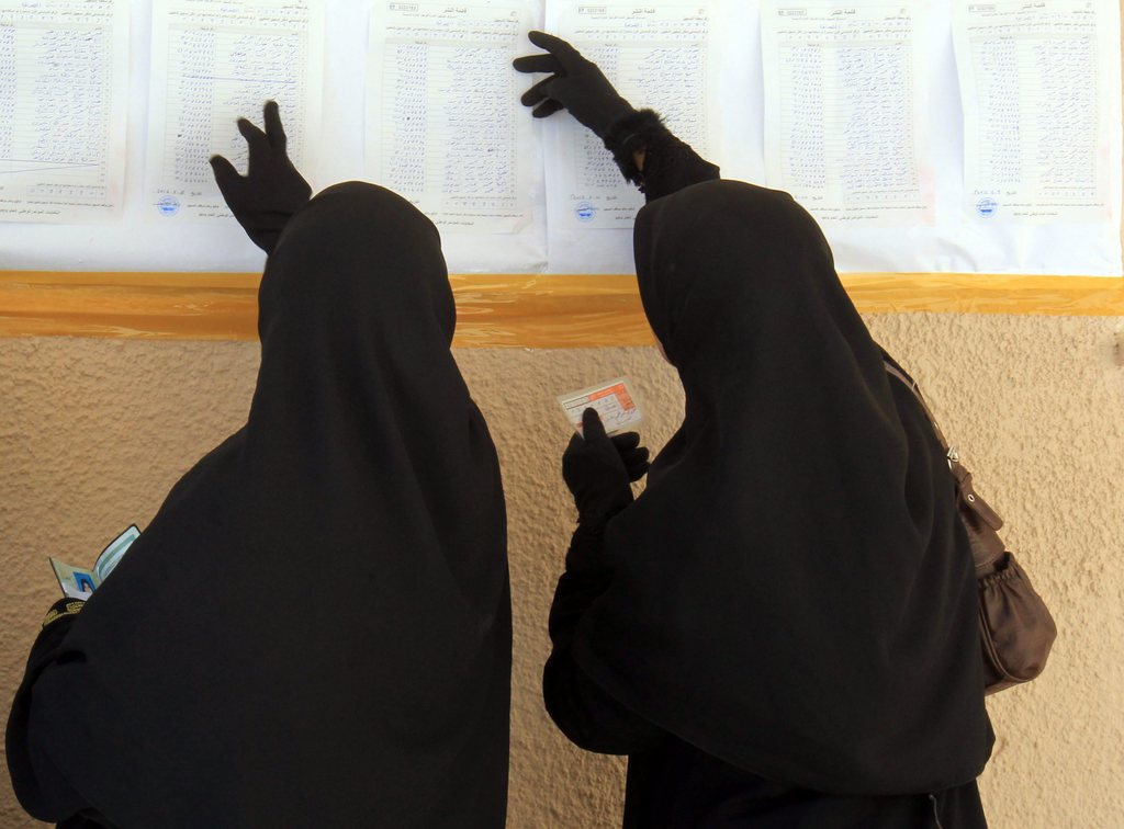 epa03299073 Libyan women check for their names on a voters list before casting their votes in the National Congress elections, at a polling station, in Benghazi, Libya, 07 July 2012. Voters headed to the polls across Libya on 07 July to elect a 200-seat National Congress, which will have legislative powers and appoint a new government, amid fears of violence and calls for boycott in eastern cities. Around 2.7 million Libyans have registered to vote to elect the assembly, consisting of 120 directly elected members and 80 contenders from party lists.  EPA/AMEL PAIN