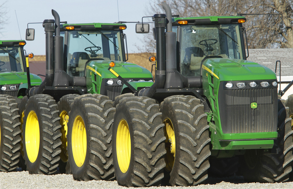 This Jan. 6, 2012 photo, shows John Deere farm tractors at Sloan's Implement John Deere Dealership in Virden, Ill. Deere & Co. will boost capacity by 10 percent at an Iowa operation that produces large farm tractors, the company said Thursday.(AP Photo/Seth Perlman)