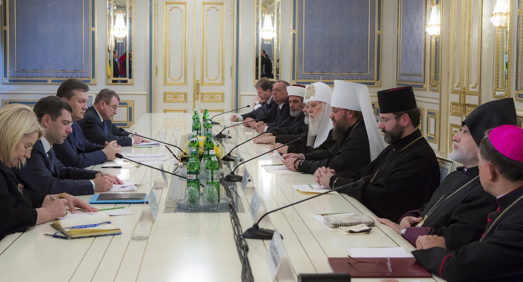 President Viktor Yanukovych, third left, meets with religious leaders in Kiev, Friday, Jan. 24, 2014. President Viktor Yanukovych promised Friday to reshuffle his government, free scores of protesters from jail and make other concessions after demonstrations against him spread from Ukraine's besieged capital to nearly half of the country. (AP Photo/Andrei Mosienko, Presidential Press Service, Pool)