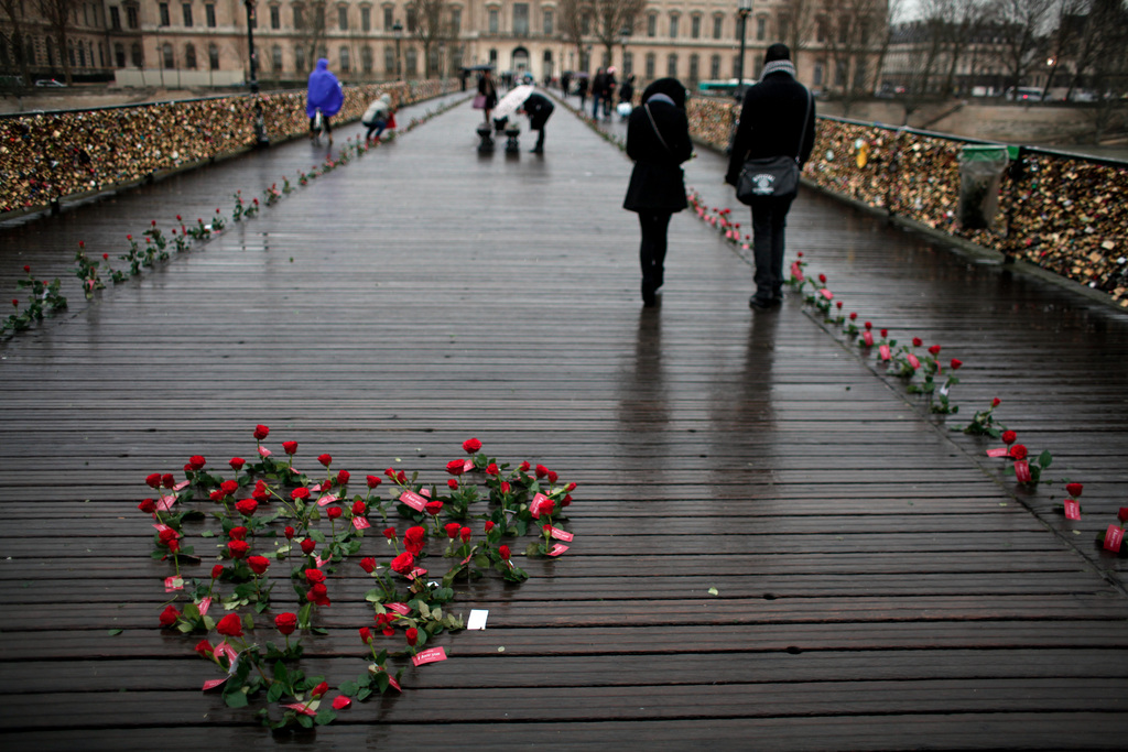 Roses are displayed on the Pont des Arts bridge by French watchmaker Sismeek, to mark the Valentine's Day, in Paris, Friday, Feb. 14, 2014. Valentine's Day is observed on February 14 each year as a special day to celebrate love and romance. (AP Photo/Thibault Camus)