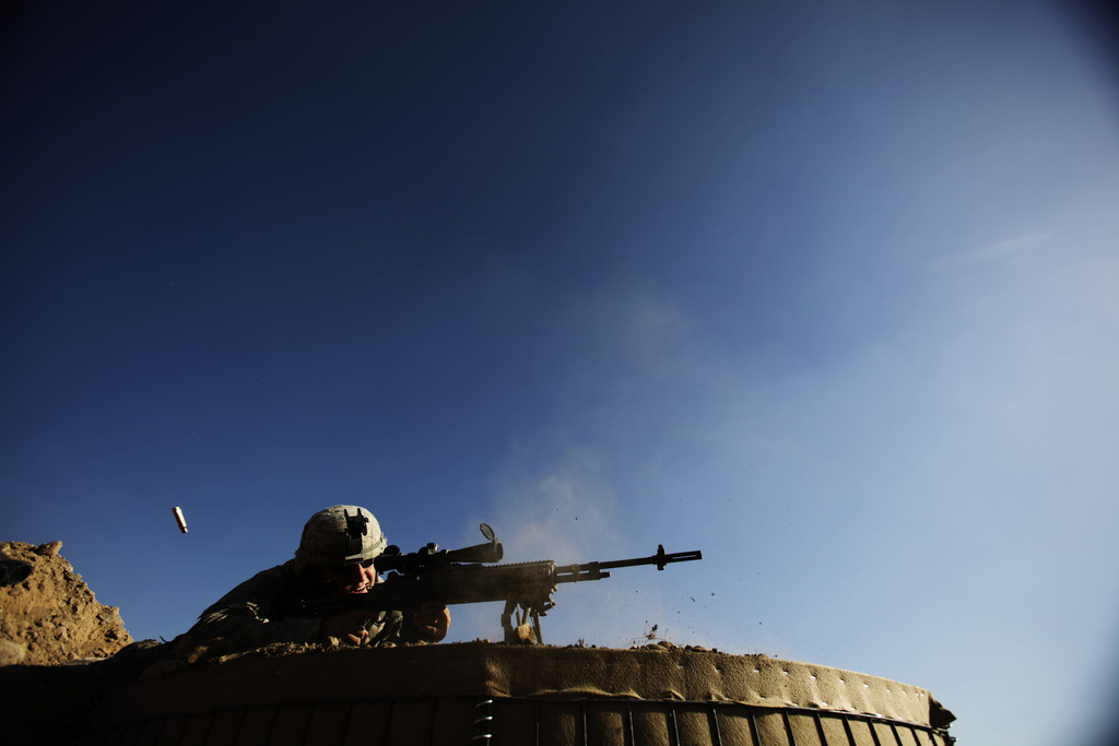 Pfc. Jeremy Theisen, from Boulder, Colorado, member of the U.S. Army's 3rd Battalion, 509th Infantry Regiment (Airborne), based at Fort Richardson, Alaska, trains his weapon at a base in Zerok District, East Paktika province in Afghanistan, Sunday, Sept. 20, 2009. (AP Photo/Dima Gavrysh)
