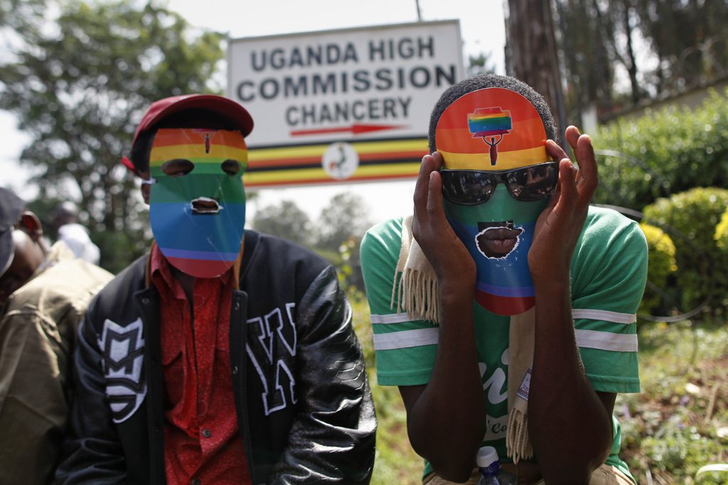 epa04066243 Masked Kenyan supporters of the LGBT community stage a protest against Uganda's anti-gay bill in front of the Ugandan High Commission in Nairobi, Kenya, 10 February 2014. Ugandan President Yoweri Museveni is to decide before 16 February whether or not to enact the proposed anti-gay law, which would mean homosexuals in Uganda would face life imprisonment.  EPA/DAI KUROKAWA