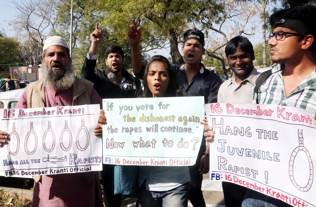 epa04123170 Indian protesters shout slogans demanding death sentence for the juveniles involved in a rape case, outside Delhi high court in New Delhi, India, 13 March 2014. The Delhi High Court confirmed the death sentences of four men convicted in the gang rape and murder of a 23-year-old student in the city after Indian court rejected their appeal - Mukesh Singh, Akshay Thakur, Vinay Sharma, and Pawan Gupta - in a case which shocked the country. The 2012 December Delhi gang rape led to protests across the country and international outrage, prompting the government to amend laws to apply stricter punishments for rape.  EPA/MONEY SHARMA