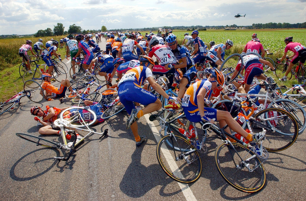 Riders of the pack get stuck with their bicycles after a massive fall during the fifth stage of the Tour de France cycling race between Soissons, northern France, and Rouen, western France, Thursday July 11, 2002. (AP Photo/Bruno Fablet/Pool)
