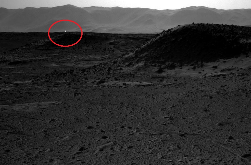 This image taken by NASA's Curiosity Mars rover's right-eye camera of the stereo Navcam on April 3, 2014 includes a bright spot, upper left, which might be due to the sun glinting off a rock or cosmic rays striking the camera's detector. Bright spots appear in images from the rover nearly every week. Typical explanations for them are cosmic rays hitting the light detector or sunlight glinting from rocks.  (AP Photo/NASA)