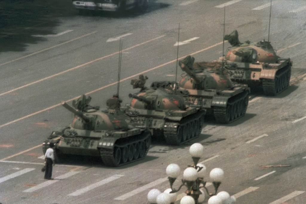 FILE - In this June 5, 1989 file photo, a Chinese man stands alone to block a line of tanks heading east on Beijing's Changan Blvd. from Tiananmen Square in Beijing. A quarter century after the Communist Party?s attack on demonstrations centered on Tiananmen Square on June 4, 1989, the ruling party prohibits public discussion and 1989 is banned from textbooks and Chinese websites. (AP Photo/Jeff Widener, File)