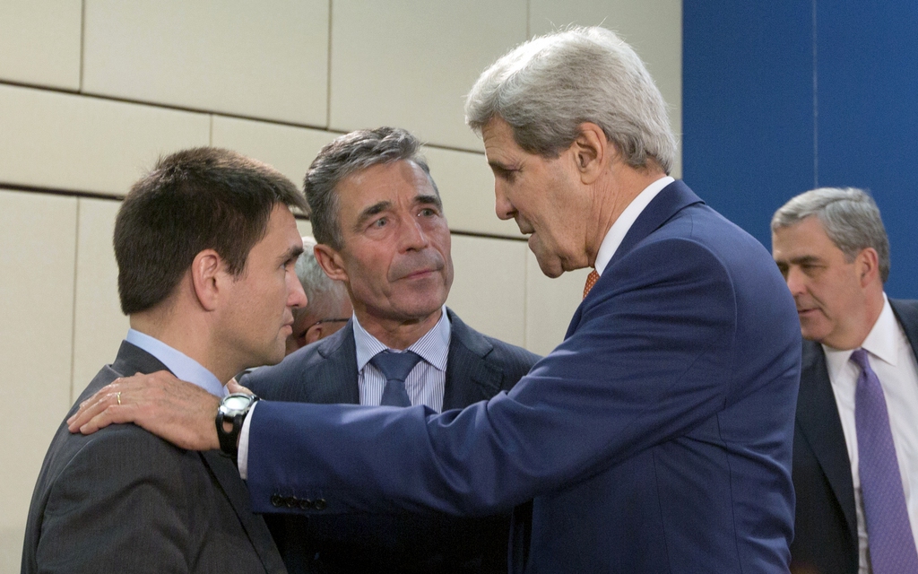 Ukrainian Foreign Minister  Klimkin, left, speaks with NATO Secretary General Anders Fogh Rasmussen, center, and U.S. Secretary of State John Kerry, second right, during a meeting of the NATO-Ukraine Commission at NATO headquarters in Brussels on Wednesday, June 25, 2014. Wednesday?s meeting will discuss how NATO can help build Ukraine?s military capacities, including by creating targeted trust funds. (AP Photo/Virginia Mayo)