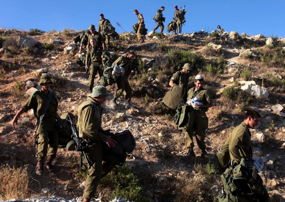 epa04276736 Israeli soldiers clamber down a steep hill as they begin searching the hills near the West Bank town of Halhoul, near Hebron, 24 June 2014. Israeli forces continued the search for three missing Israeli teenagers, although the massive operation to find them was losing steam, officials said. The three went missing on 12 June from a common hitchhike stop near a settlement block south of Jerusalem. Although Israel says its has 'unequivocal proof' that the Palestinian Islamist movement Hamas abducted them, no group has claimed responsibility for the disappearances yet.  EPA/ABED AL HASHLAMOUN