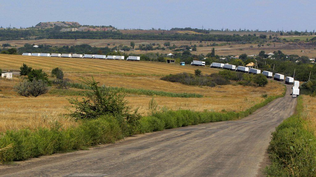 The first trucks of the convoy roll on the main road to Luhansk near the village of Uralo-Kavkaz, after it passed the border post at Izvaryne, eastern Ukraine, Friday, Aug. 22, 2014. The first trucks in a Russian aid convoy crossed into eastern Ukraine on Friday, seemingly without Kiev's approval, after more than a week's delay amid suspicions the mission was being used as a cover for an invasion by Moscow. (AP Photo/Sergei Grits)