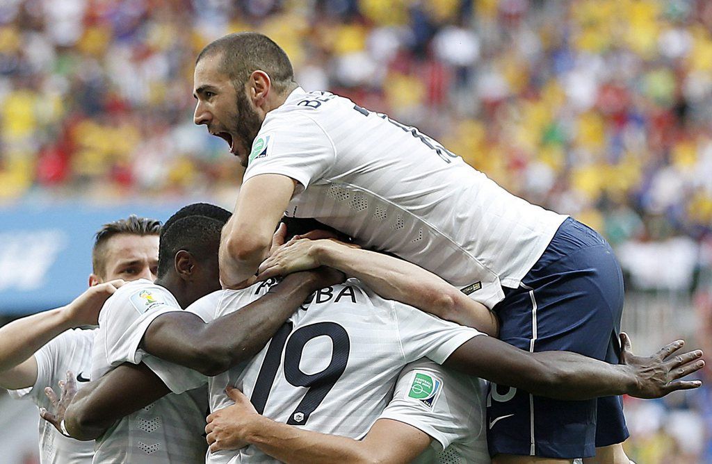 epa04292024 Paul Pogba (C) of France celebrates with teammates after scoring the opening goal during the FIFA World Cup 2014 round of 16 match between France and Nigeria at the Estadio Nacional in Brasilia, Brazil, 30 June 2014. ....(RESTRICTIONS APPLY: Editorial Use Only, not used in association with any commercial entity - Images must not be used in any form of alert service or push service of any kind including via mobile alert services, downloads to mobile devices or MMS messaging - Images must appear as still images and must not emulate match action video footage - No alteration is made to, and no text or image is superimposed over, any published image which: (a) intentionally obscures or removes a sponsor identification image; or (b) adds or overlays the commercial identification of any third party which is not officially associated with the FIFA World Cup)  EPA/JORGE ZAPATA   EDITORIAL USE ONLY