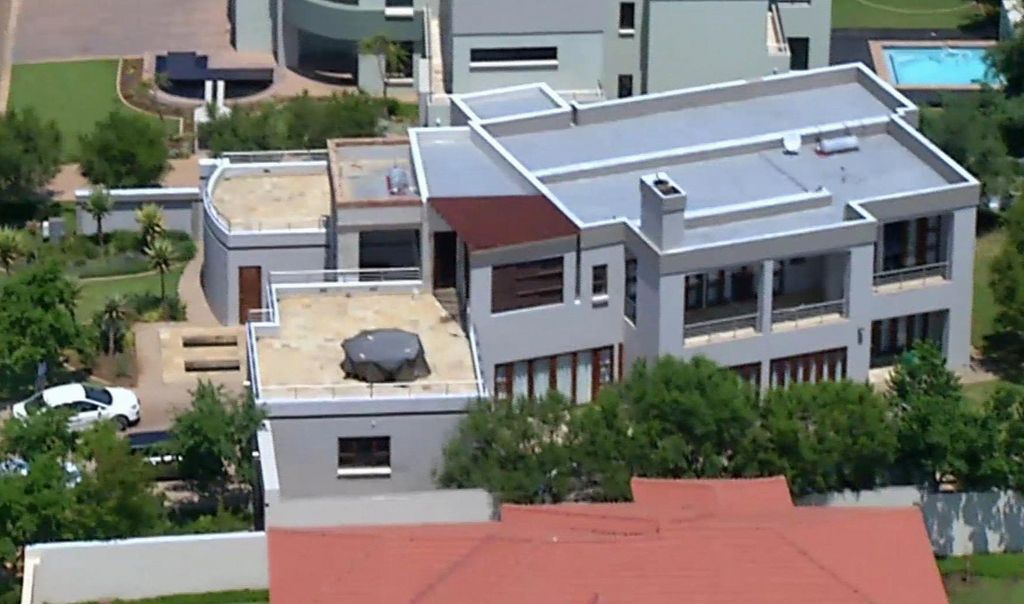 File - This file aerial image taken from video provided by VNS24/7 on Thursday, Feb. 14, 2013, shows the home of Olympic athlete Oscar Pistorius in a gated housing complex in Pretoria, South Africa. Oscar Pistorius is selling the house where  Reeva Steenkamp was kiiled  to raise money for his legal bills, and has still never returned to the upscale villa since the day he shot his girlfriend in an upstairs bathroom over a year ago, the athlete?s lawyer said Thursday. (AP Photo/VNS24/7-File)