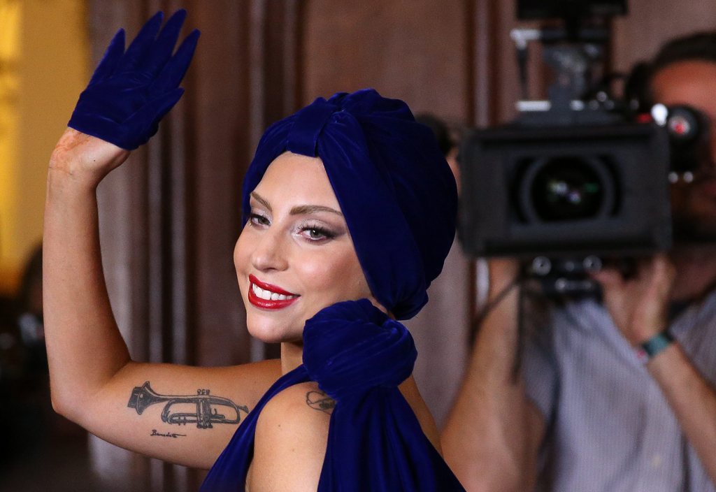 epa04412423 US singers Lady Gaga waves during a press conference in Brussels, Belgium, 22 September 2014. Lady Gaga is in Brussels to shoot a music video with US singer Tony Bennett at the city's Grand Place later the same day.  EPA/JULIEN WARNAND