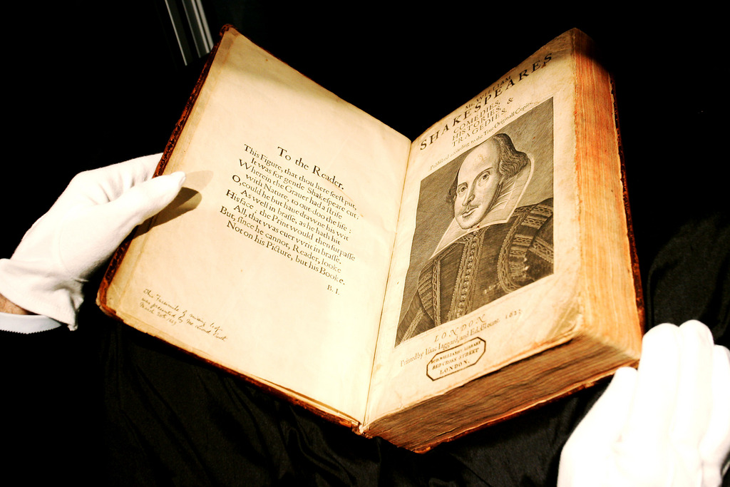 An auction house staff checks the 1623 First Folio edition of Shakespeare's plays on display at Sotheby's auction house in London, Monday, July 10, 2006. The folio is to be auctioned in English Literature and History Sale at Sotheby's in London on July 13 with an estimated price of 2.5 to 3.5 millon (US$4.6 to 6.5millon, 3.6 to 5 million Euro).  (AP Photo/Sang Tan)