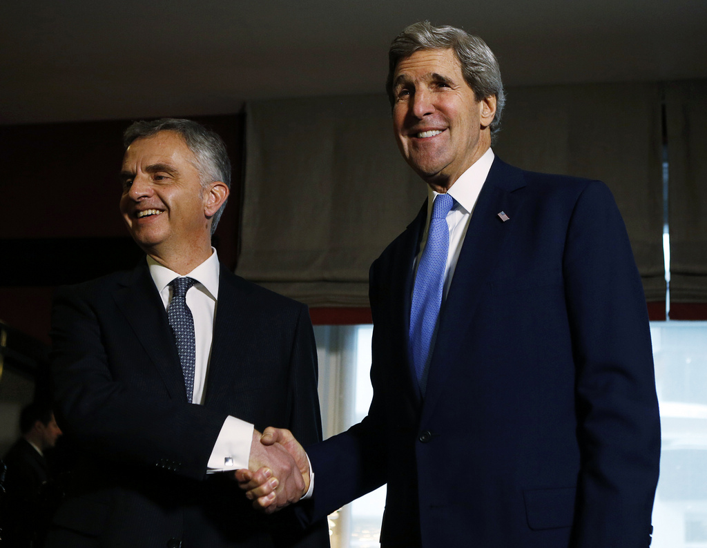 U.S. Secretary of State John Kerry, right, poses with Swiss President Didier Burkhalter for photographers in Davos, Switzerland, Friday, Jan. 24, 2014. Kerry is attending the annual World Economic Forum meeting in the Swiss Alps. (AP Photo/Gary Cameron, Pool)