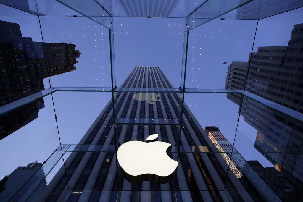 The Apple logo hangs in the glass box entrance to the company's Fifth Avenue store, Thursday, Sept. 5, 2014 in New York. (AP Photo/Mark Lennihan)