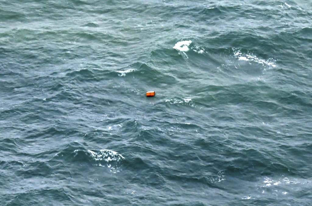 epa04542683 An unidentified object, found during a search and rescue operation by the Indonesian Air Force for the missing AirAsia plane, is seen floating in the ocean off the coast of Pangkalan Bun, Borneo, Indonesia, 30 December 2014.  The search operation for a missing AirAsia plane has 'possibly' found debris, including what looks like a life vest and a seat, Indonesia's Air Force spokesman says.  One of the floating objects spotted by an aircraft looking for the missing AirAsia plane resembles an emergency slide, an Air Force officer said.  EPA/KENAREL BEST AVAILABLE QUALITY