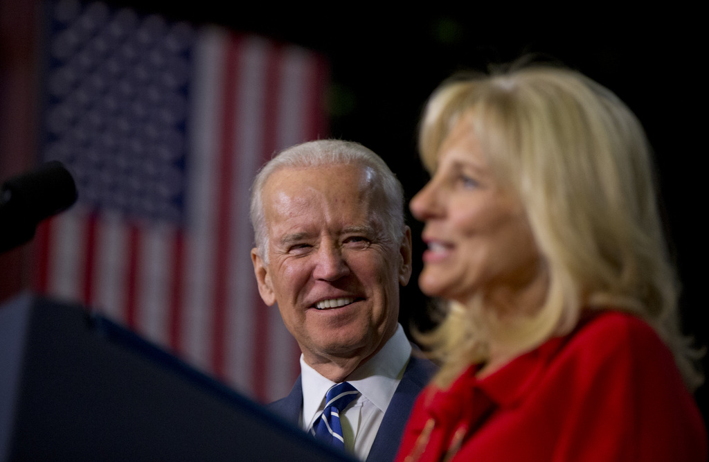 Vice President Joe Biden listens as his wife Jill Biden speaks at Pellissippi State Community College, Friday, Jan. 9, 2015, in Knoxville, Tenn., about new initiatives to help more Americans go to college and get the skills they need to succeed. (AP Photo/Carolyn Kaster)