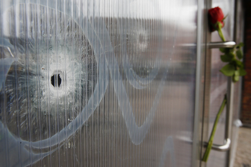 Bullet holes are seen in the window of the cultural center one of the locations of the weekend shootings in Copenhagen, Denmark, Tuesday, Feb. 17, 2015.   A Danish gunman who attacked a free-speech seminar and a synagogue was released about two weeks ago from a jail where he may have been radicalized while serving time for a vicious stabbing. As Denmark mourned the two victims, these and other troubling details emerged Monday about Omar Abdel Hamid El-Hussein's path to the country's worst terror spree in three decades.(AP Photo/Michael Probst)