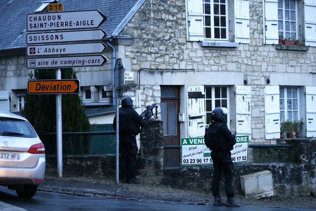 epa04551246 Police officers patrol during the manhunt for the suspects in the shooting attack at the satirical French magazine Charlie Hebdo headquarters on 07 January, in Longpont, near Villers Cotterets, north-east of Paris, Aisne region, France, 08 January 2015.  Police released photos overnight of Cherif Kouachi, 32, and Said Kouachi, 34, warning that they were likely 'armed and dangerous.' Investigators also detained seven people with close links to the suspects for questioning, French media reported. The two suspects were spotted by civilians on the morning of 08 January in northern France.  EPA/YOAN VALAT