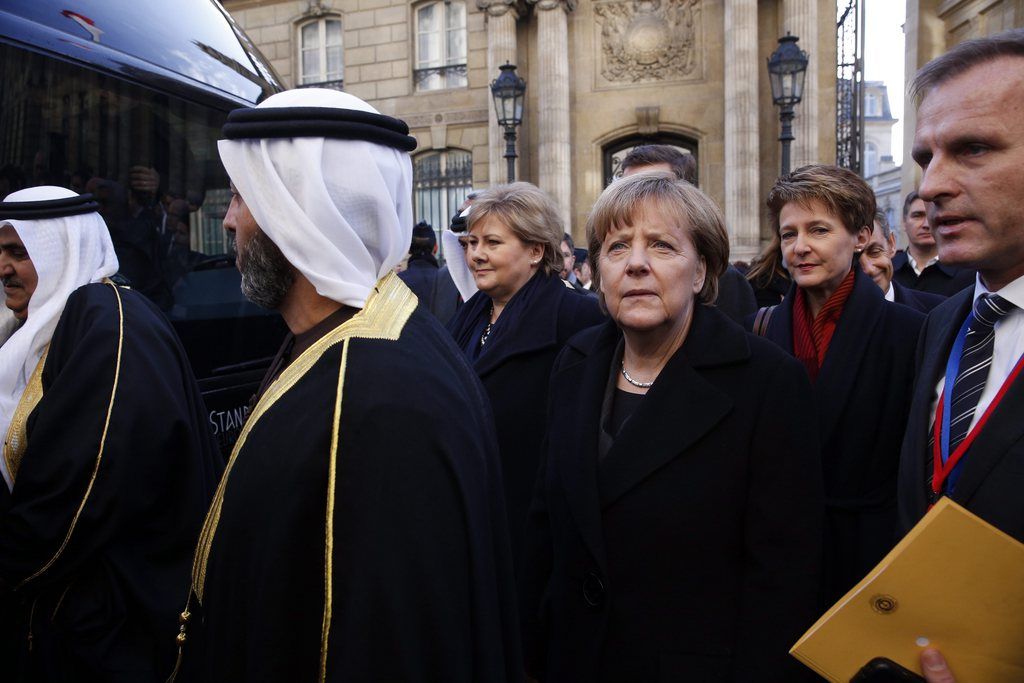 epa04555096 German Chancellor Angela Merkel (C) and Switzerland's Federal President Simonetta Sommaruga (C right) leave the Elysee Palace to participate in a march to honor the victims of the terrorist attacks and to show unity, in Paris, France, 11 January 2015. Three days of terror that ended on 10 January saw 17 people killed in attacks that began with gunmen invading French satirical magazine Charlie Hebdo and continued with the shooting of a policewoman and the siege of a Jewish supermarket.  EPA/YOAN VALAT MAXPPP OUT