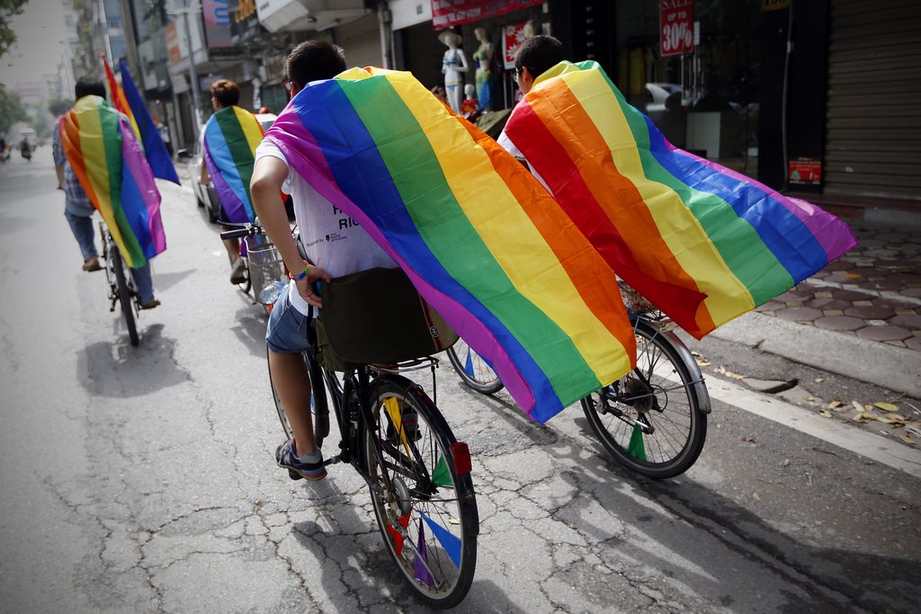epa04339394 People ride bicycles as they take part in the third Viet Pride parade at a street in Hanoi, Vietnam, 03 August 2014. Around 400 people took part in a colorful bicycle parade through the centre of Hanoi Sunday morning, marking the third annual Viet Pride, the country's version of Gay Pride. Participants wore matching t-shirts and carried rainbow flags - a popular symbol of lesbian, gay, bisexual, and transgender (LGBT) pride. Vietnam's LGBT rights activists have become more visible in recent years, with several high-profile campaigns. The most recent was an attempt to legalise same-sex marriage as the National Assembly debated revisions to the Marriage and Family Law. However, while legislators removed a ban on such weddings, they did not legalise them.   The first Pride was held in the United States in 1969. The event has since become a symbol of the LGBT movement across the world.  EPA/LUONG THAI LINH