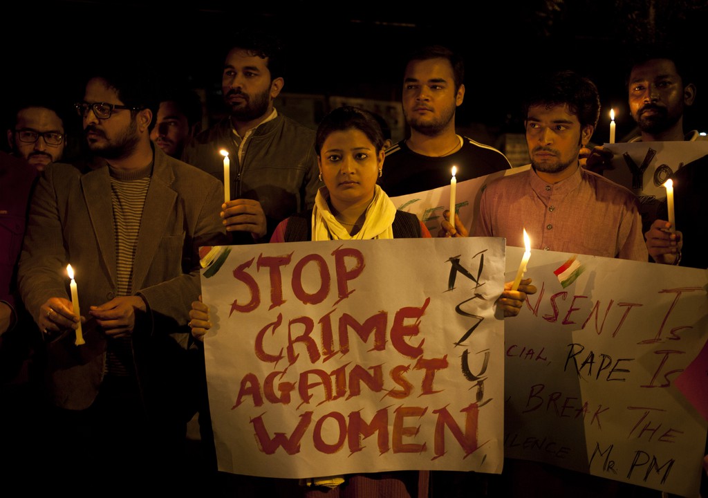 Indian youth hold candles during a protest against sexual violence in New Delhi, India, Monday, Feb. 9, 2015.Police were searching Monday for a man who raped a Japanese student sightseeing in northern India, while elsewhere they announced the arrest of eight men suspected of brutally raping and killing a Nepalese woman, as India authorities continue to struggle to address chronic sexual violence. (AP Photo/ Tsering Topgyal)