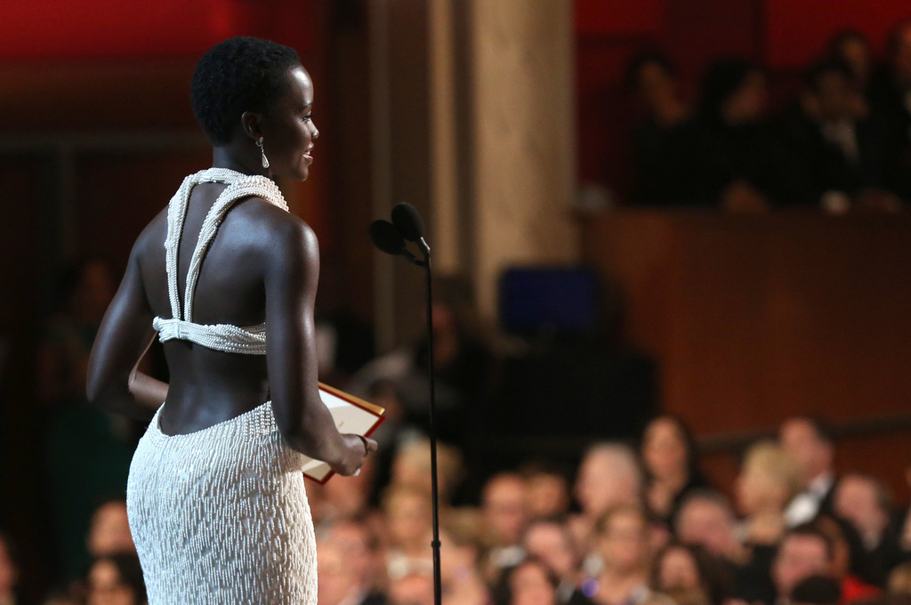 Lupita Nyong'o is seen from backstage as she presents the award for best actor in a supporting role at the Oscars on Sunday, Feb. 22, 2015, at the Dolby Theatre in Los Angeles. (Photo by Matt Sayles/Invision/AP)