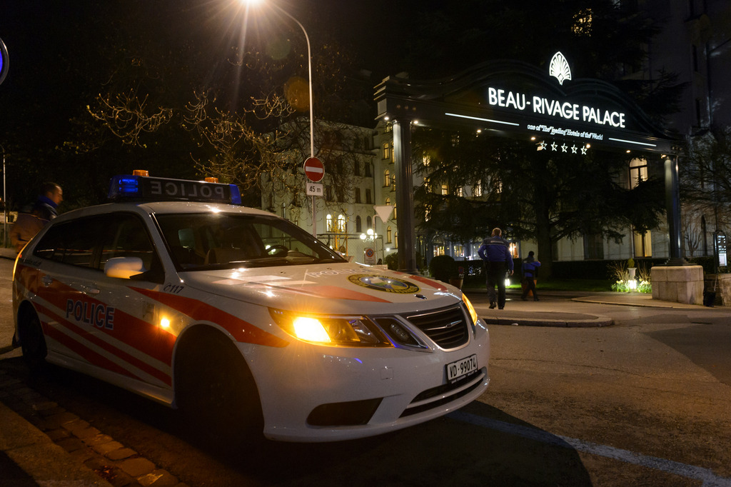 Two Police officers patrols outside the Beau Rivage Palace Hotel as Iran nuclear program talks continue into the night, , in Lausanne, Switzerland, Wednesday, April 1, 2015. (KEYSTONE/Laurent Gillieron)