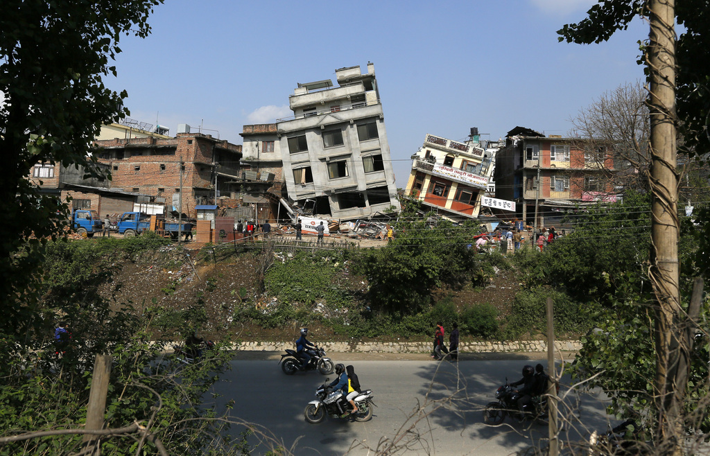 Damaged buildings lean to their sides in Kathmandu, Nepal, Monday, April 27, 2015. A strong magnitude 7.8 earthquake shook Nepal's capital and the densely populated Kathmandu Valley on Saturday, causing extensive damage with toppled walls and collapsed buildings. (AP Photo/Wally Santana)