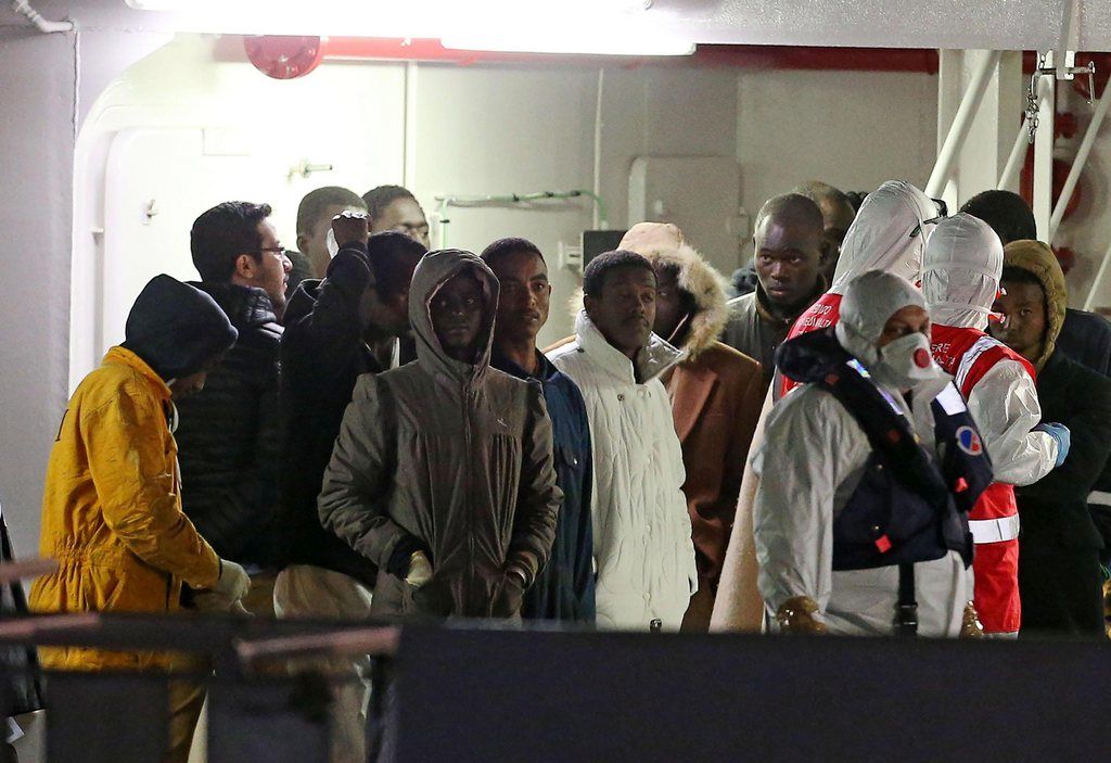 epa04713891 Surviving wreckship migrants aboard Italian coastguard ship Bruno Gregoretti arrive at Catania's port early Tuesday, Italy, 21 April 2015. Italian Coast Guard vessel Bruno Gregoretti arrived at the port of Valletta on Monday morning, carrying 24 bodies and 27 out of the 28 survivors of a shipwreck off the Libyan coast believed to have caused as many as 900 deaths. Right after the remains of victims were taken ashore where survivors underwent a medical checkup, the Gregoretti was scheduled to leave for the Sicilian city of Catania.  EPA/ALESSANDRO DI MEO