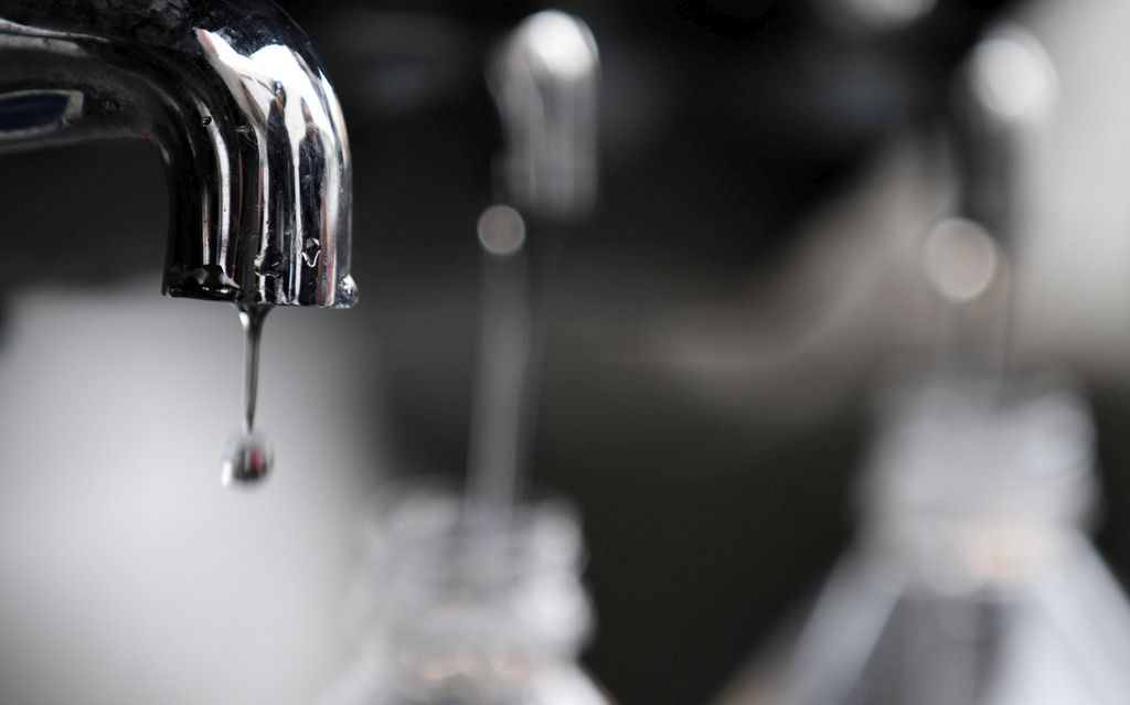 Water drips from a faucet as water bottles are filled at an emergency center on Sunday, March 13, 2011, in Koriyama, Japan, two days after a giant quake and tsunami struck the country's northeastern coast.(AP Photo/Gregory Bull)