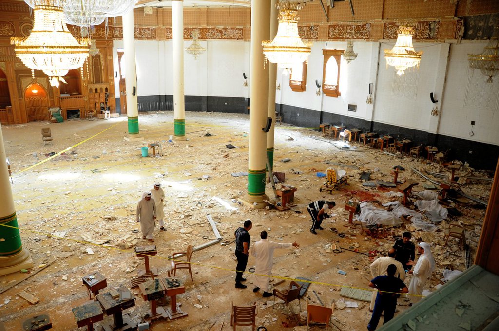 epaselect epa04820003 Medics and security forces gather inside Imam Sadiq Mosque following a suicide bombing in al-Sawaber, Kuwait City, Kuwait, 26 June 2015. Media reports said 24 people were killed and 25 wounded in a suicide bombing at a Shiite mosque in Kuwait where worshippers had gathered for Friday prayers during the holy month of Ramadan. The Islamic State extremist group claimed responsibility for the attack, according to a statement circulated on social media which could not be immediately verified.  EPA/RAED QUTENA