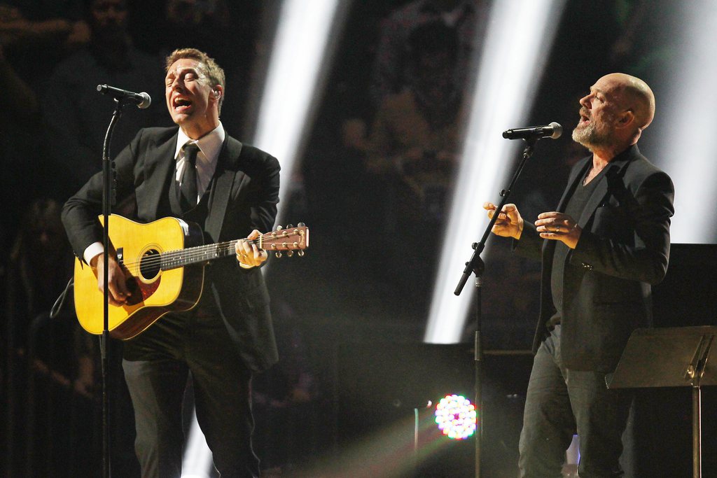 This image released by Starpix shows Chris Martin, left, and Michael Stipe at the 12-12-12 The Concert for Sandy Relief at Madison Square Garden in New York on Wednesday, Dec. 12, 2012. Proceeds from the show will be distributed through the Robin Hood Foundation. (AP Photo/Starpix, Dave Allocca)