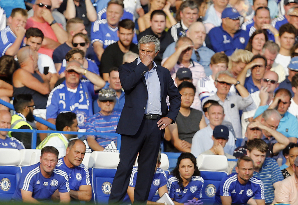 Chelsea's manager Jose Mourinho covers his face during the English Premier League soccer match between Chelsea and Swansea City at Stamford Bridge stadium in London, Saturday, Aug. 8, 2015.(AP Photo/Frank Augstein)