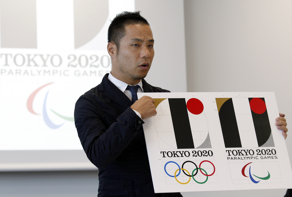 Japanese designer Kenjiro Sano gives a detailed explanation of how he came up with his logo for the 2020 Tokyo Olympics at a press conference in Tokyo, Wednesday, Aug. 5, 2015.  Sano refuted claims Wednesday that he copied the emblem of a Belgian theater when he created the official logo for the 2020 Tokyo Olympics. Belgian designer Olivier Debie has asked the International Olympic Committee and Tokyo Olympic organizers to change the logo because it bears too much resemblance to his emblem for the theater in the city of Liege. (AP Photo/Ken Aragaki)
