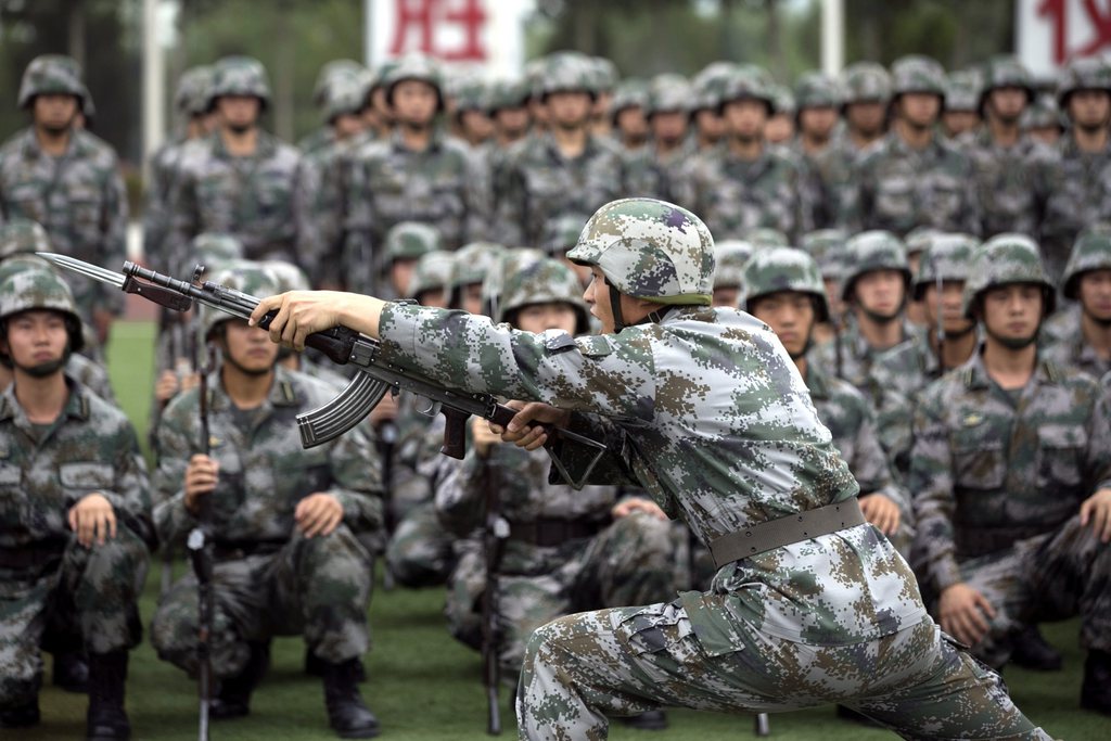 epa04325790 A training officer demonstrates the use of a rifle with a knife extension as cadets watch at the People's Liberation Army (PLA) Academy of Armored Forces Engineering in Beijing, China 22 July 2014. Aside from providing training in combat related skills, the academy also trains Chinese cadets in mechanical, electronic and various scientific fields that can be used in China's military program.  EPA/ROLEX DELA PENA
