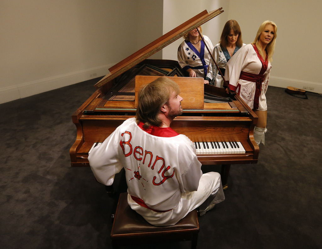 Actors of the ABBA show 'Bjoern Again' perform on a piano at Sotheby's auction house in London, Thursday, Aug. 27, 2015. A grand piano that featured on many of ABBA's biggest hits is going up for auction in London. Sotheby's is offering the instrument, owned by the Stockholm recording studio where the Swedish pop group often recorded. (AP Photo/Frank Augstein)