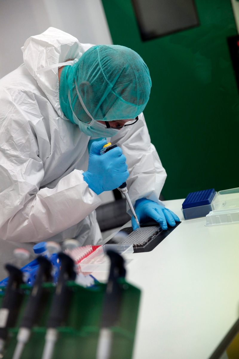 epa04686942 A forensic scientist of the Criminal Research Institute of the National Gendarmerie (IRCGN), collects DNA taken from the body parts of people involved in the crash of Germanwings jetliner, in Pontoise, outside Paris, France, 30 March 2015. The process of identifying the victims of Germanwings crash has now entered its active phase, but the families will still have to wait months to find out if their loved ones are among the bodies found.  EPA/Christophe Ena / POOL POOL FRANCE GERMANWINGS PLANE CRASH AFTERMATH