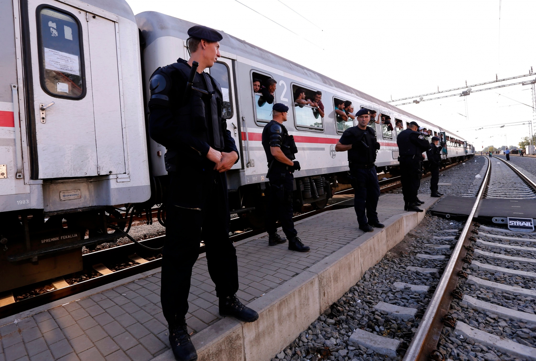 epa04945056 Police guard a train for Hungary at Tovarnik border town, Croatia, 23 September 2015. More and more migrants are arriving in Croatia via alternative routes to reach the European Union. Serbia's border with Croatia has become the latest flashpoint in Europe's refugee crisis as migrants sought alternative routes to Western Europe after Hungary slammed its doors shut. Hungary on 15 September sealed the last gap in the barricade along its border with Serbia, closing the passage to thousands of refugees and migrants still waiting on the other side and some groups decided to pass over Croatia.  EPA/ANTONIO BAT CROATIA REFUGEES MIGRATION CRISIS